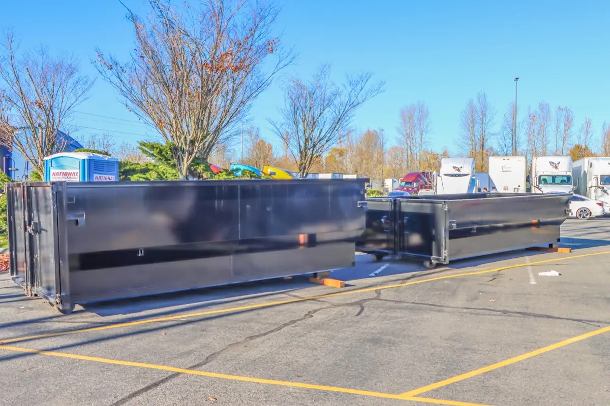 Professional dumpster rental service with roll-off container on residential driveway in Crystal City